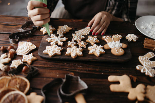 istock Woman decorating Christmas gingerbread cookies 1270211833