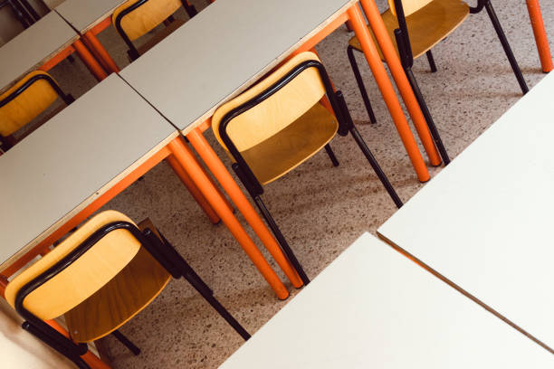 istock Desks and chairs in a classroom 1270213155