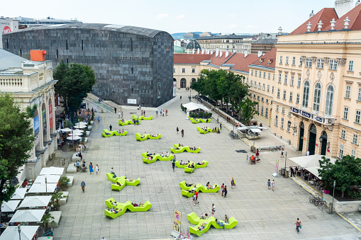 Vienna, Austria - June 3, 2017. View over Museumsplatz in the Museumsquartier in Vienna, toward Mumok and Hofstallungen complex, with people.