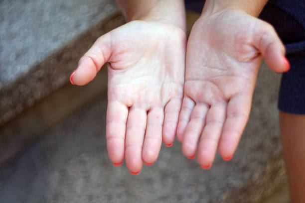 istock Child's hands holding offering giving something or asking begging for something. 1270213421