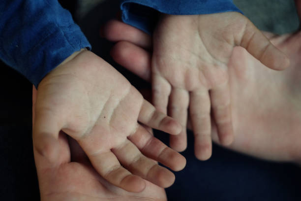 istock Child's hands holding offering giving something or asking begging for something. 1270213425