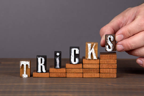 istock TRICKS concept. Wooden alphabet letters on steps. Gray background 1270213502