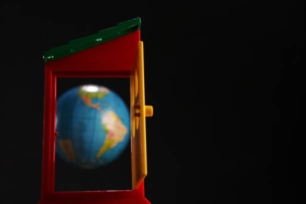 istock red toy door opened against globe on black background 1270214363