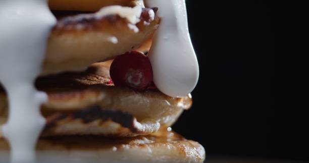 istock Stack of pancakes covered with sour cream 1270214555