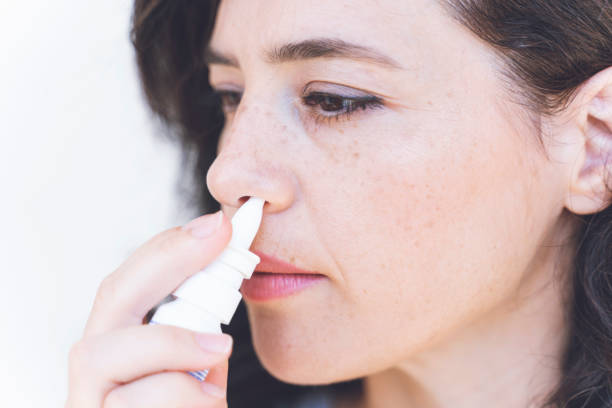 istock Relaxed young woman using nasal spray 1270214888