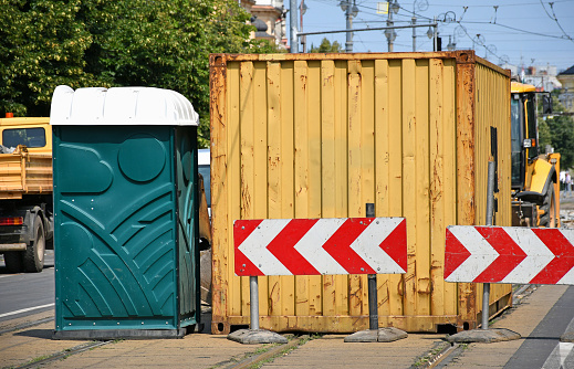 Freight transportation container and a portable toilet on the street