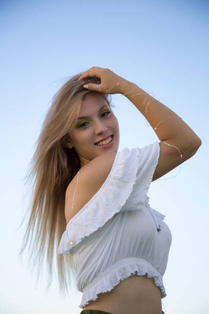 Young and beautiful female portrait with flowers and lights.