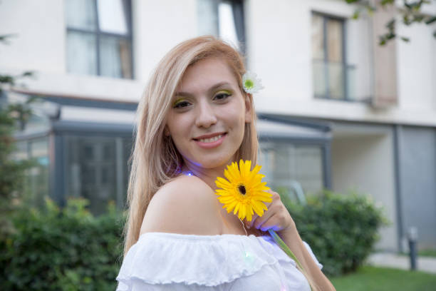 Beautiful young woman spending day in spring or summer park.