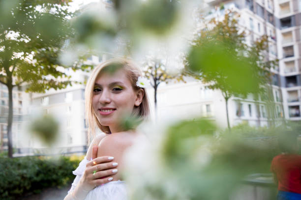 Young and beautiful female portrait with flowers and lights.