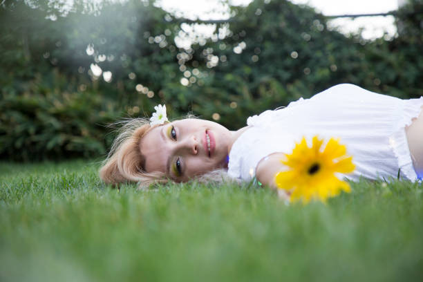 Young and beautiful female portrait with flowers and lights.