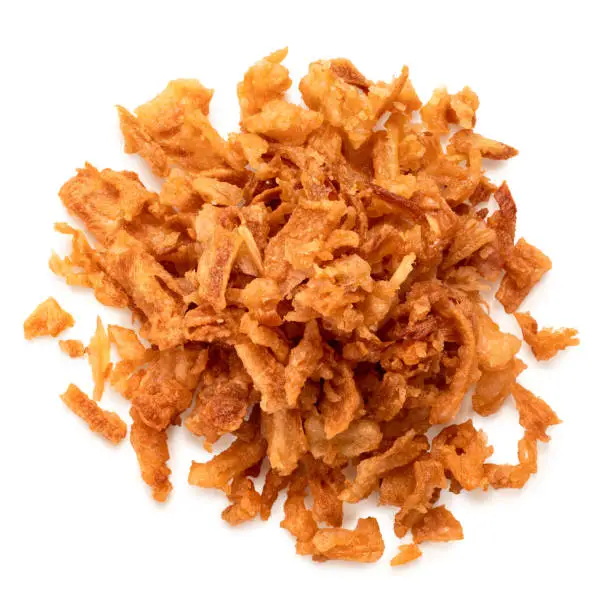 Pile of crispy fried onions isolated on white. Top view.