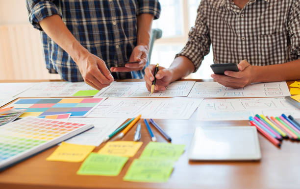 istock Two professional web designers draw the outline of an application for mobile. 1270220363