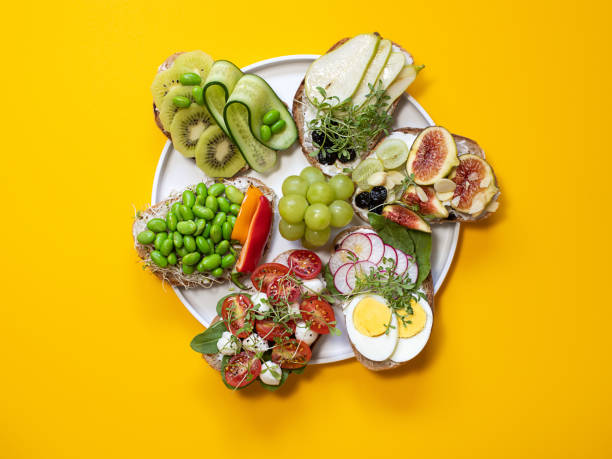 istock Bruschetta with different fillings. Isolated on yellow background, top view. 1270224779