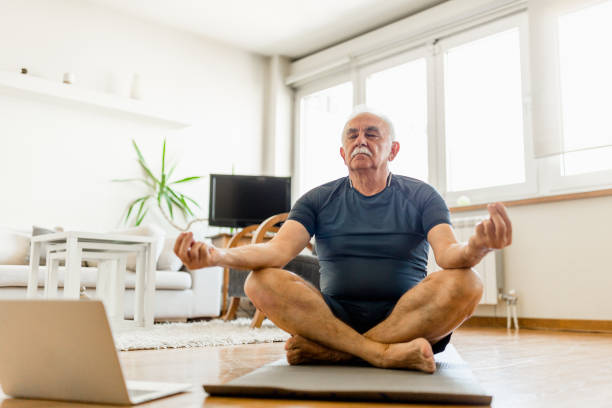istock Active senior man home exercising with online coach 1270225688