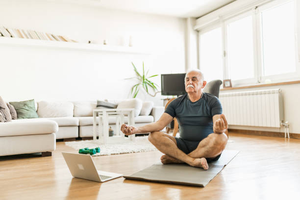 istock Active senior man home exercising with online coach 1270225692