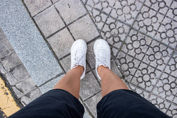 istock Foots In white sneakers 1270226016