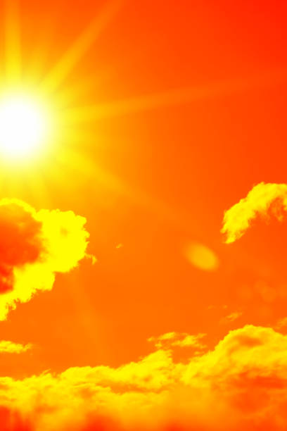 istock Bright sun with beautiful beams in the sky with clouds (toned in red) 1270227184