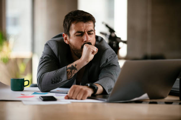 istock Tired businessman working with laptop at office. 1270227296