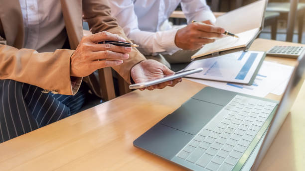 istock Business team brainstorming and discussing with financial data and report graph. Teamwork meeting working concept. 1270228906