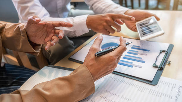 istock Business team brainstorming and discussing with financial data and report graph. Teamwork meeting working concept. 1270228937