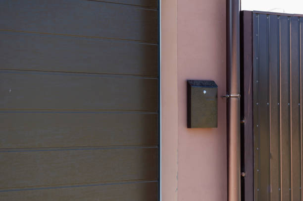 istock A brown letterbox on the pink wall next to the downpipe. 1270230391