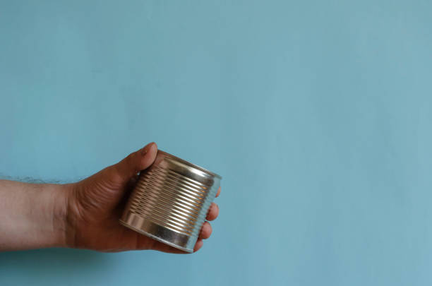 istock Hands of a man holding a tin can 1270230400