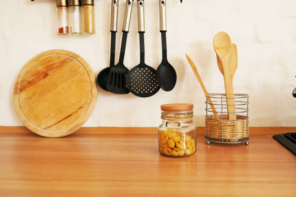 istock Kitchenware with wooden spoons in vase on wooden table 1270231849