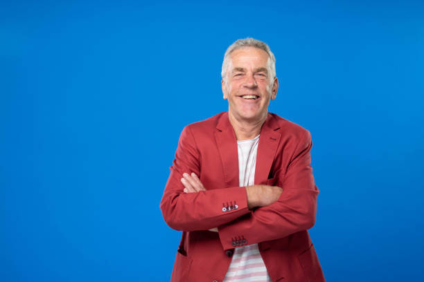 istock Senior Man Smiling With Arms Crossed On Colored Background 1270233183