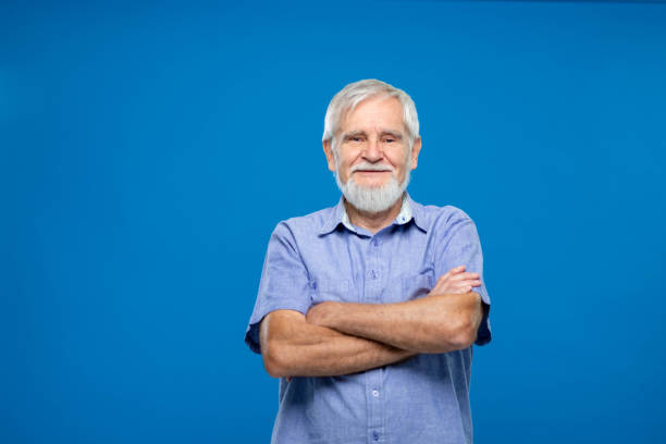 istock Senior Man Standing With Arms Crossed On Blue Background 1270233186