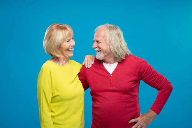 istock Senior Couple Laughing On Blue Background 1270233193