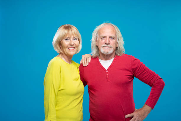 istock Senior Couple Laughing On Blue Background 1270233194