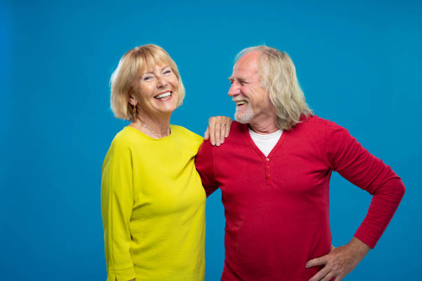 istock Senior Couple Laughing On Blue Background 1270233197