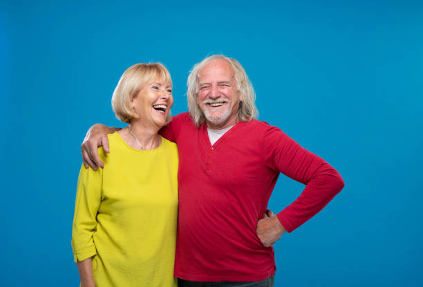 istock Senior Couple Laughing On Blue Background 1270233207