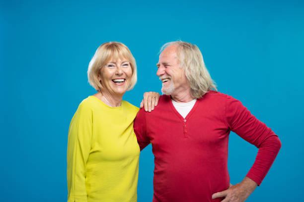 istock Senior Couple Laughing On Blue Background 1270233214