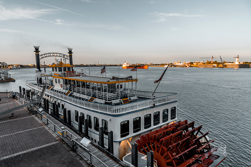 A paddle steamer is moored to a wharf on the Mississippi River in New Orleans, Louisiana.