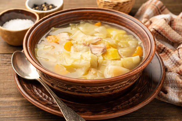 istock Homemade cabbage soup in ceramic bowl on rustic wooden background 1270243106
