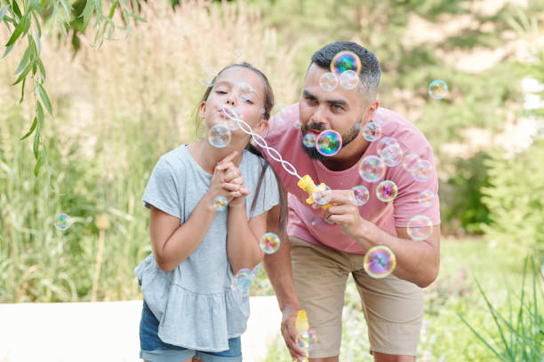 istock Father And Daughter With Soap Bubbles 1270243963