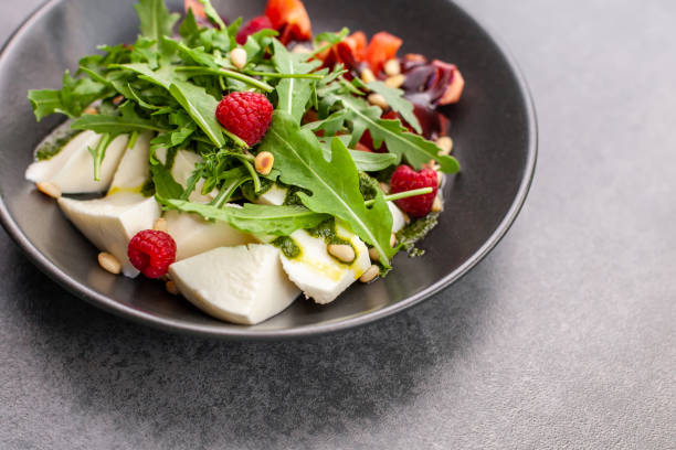 istock Salad with cottage chese, tomatoes and raspberry 1270244325