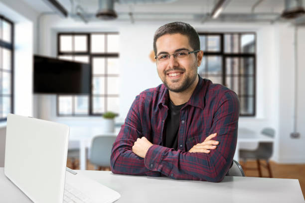 istock Young businessman using laptop in modern office 1270245771