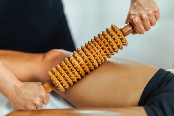 Rolling Pin Madero Therapy Massage Rolling pin madero therapy massage. Female masseuse performing cellulite reduction treatment The Rising Popularity of Wooden Massage Tools stock pictures, royalty-free photos & images