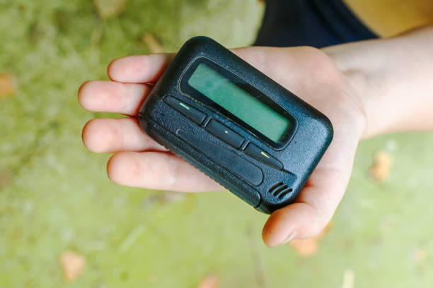 istock pagers. old vintage beeper. pager in hand 1270246160