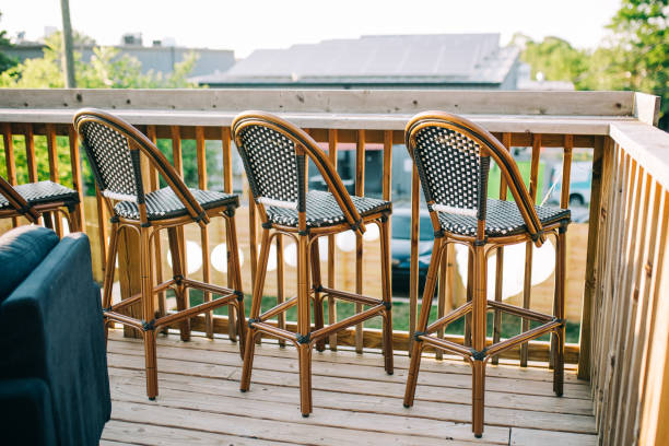 istock Tall chairs lined up against a wood deck in a backyard. 1270249017