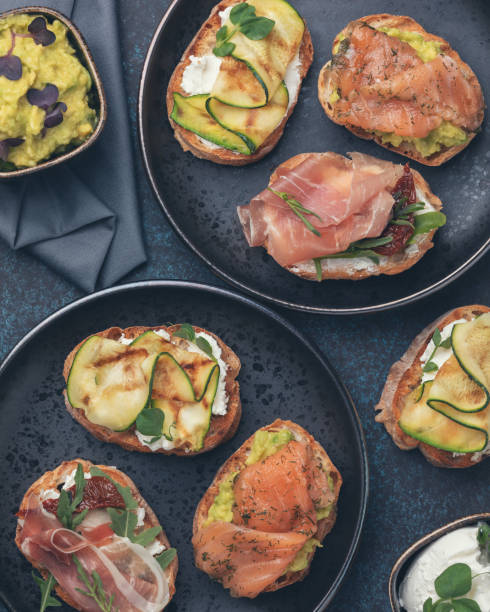 istock Assorted bruschetta with various toppings on a dark plates on dark background. Appetizing bruschetta. Mediterranean cuisine. Top view 1270251308
