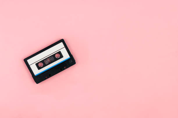 istock Audio cassette flat lay on pink background top view with copy space. Creative design in minimal retro 80-s style. Music, radio, dj concept. Banner template. Stock photo 1270254140