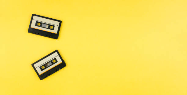 istock Audio cassettes on yellow background top view with copy space. 80-s style. Music concept. Web banner template. Stock photo. 1270254264