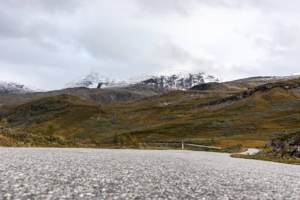 istock Mountain asphalt road, snow hills Norway landscape 1270257542