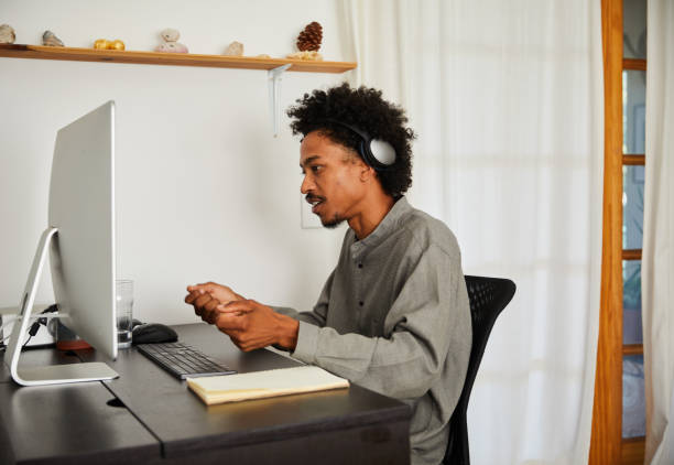 istock Young man working online on a computer in his home office 1270257545