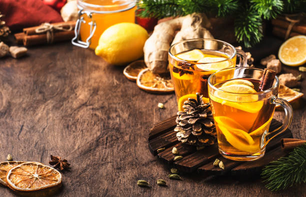 istock Healing black winter tea with ginger, honey, lemon. Immune booster drink in glass cup on rustic wooden table background with copy space 1270258564