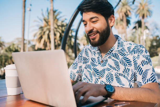 istock Young man using his laptop in a coffee shop. 1270258580