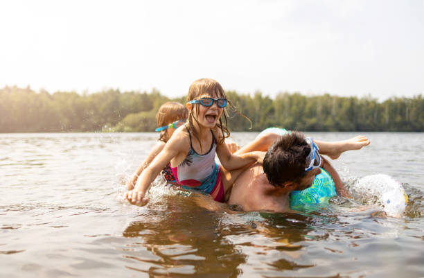 istock Father and kids having fun in the lake 1270259005
